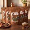 Five Kiro Ragi Chilla Idli Dhokla premix 300g pouches arranged in a fan with ragi dosa, premix flour and finger millet ears